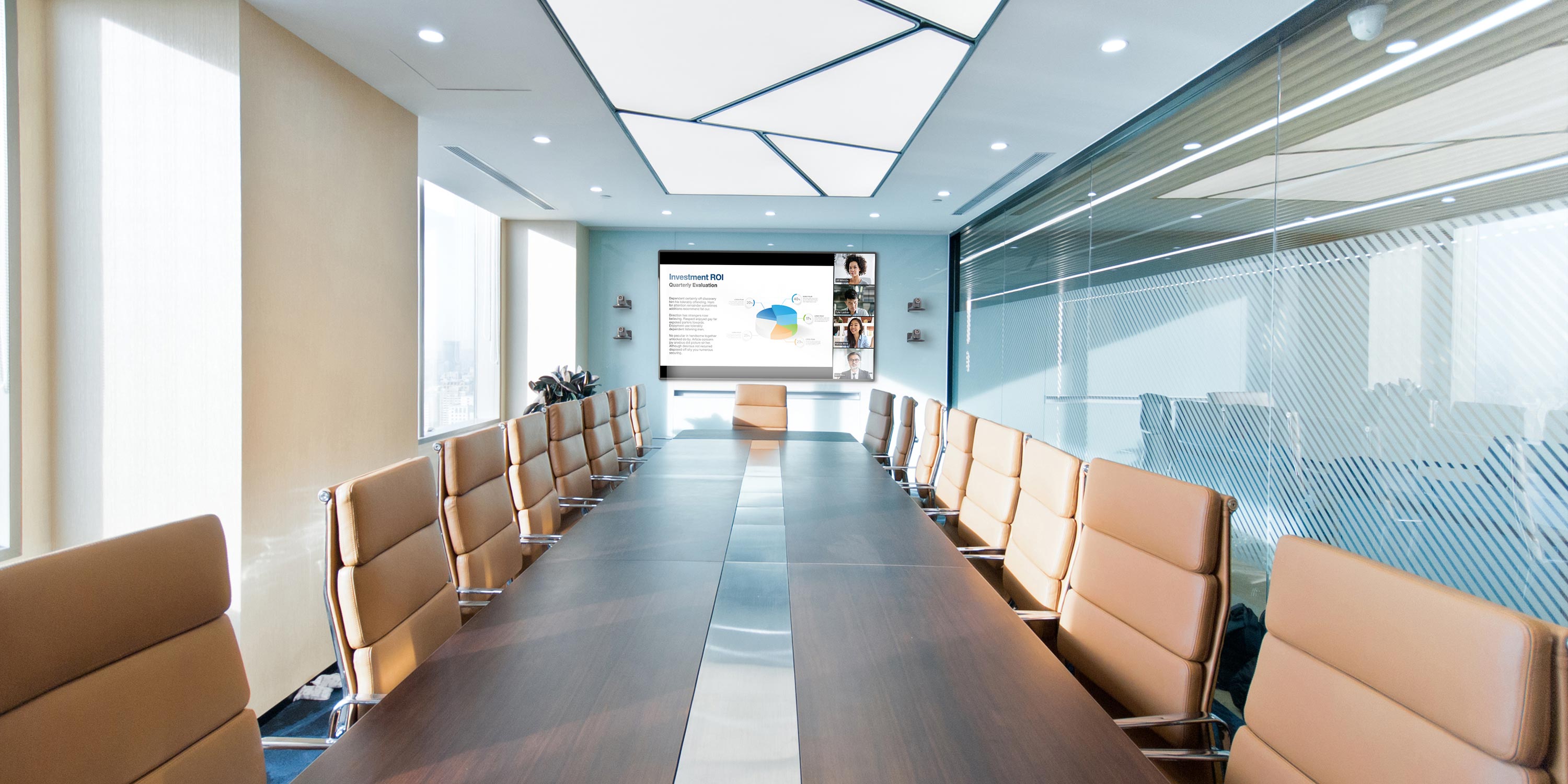 Large conference room with a video meeting displayed on a wall mounted screen