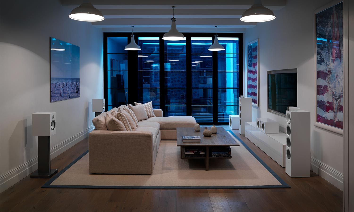 Modern living room with surround sound speakers and large sectional sofa