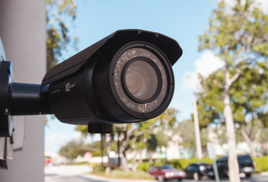 a black security camera installed on a commercial property