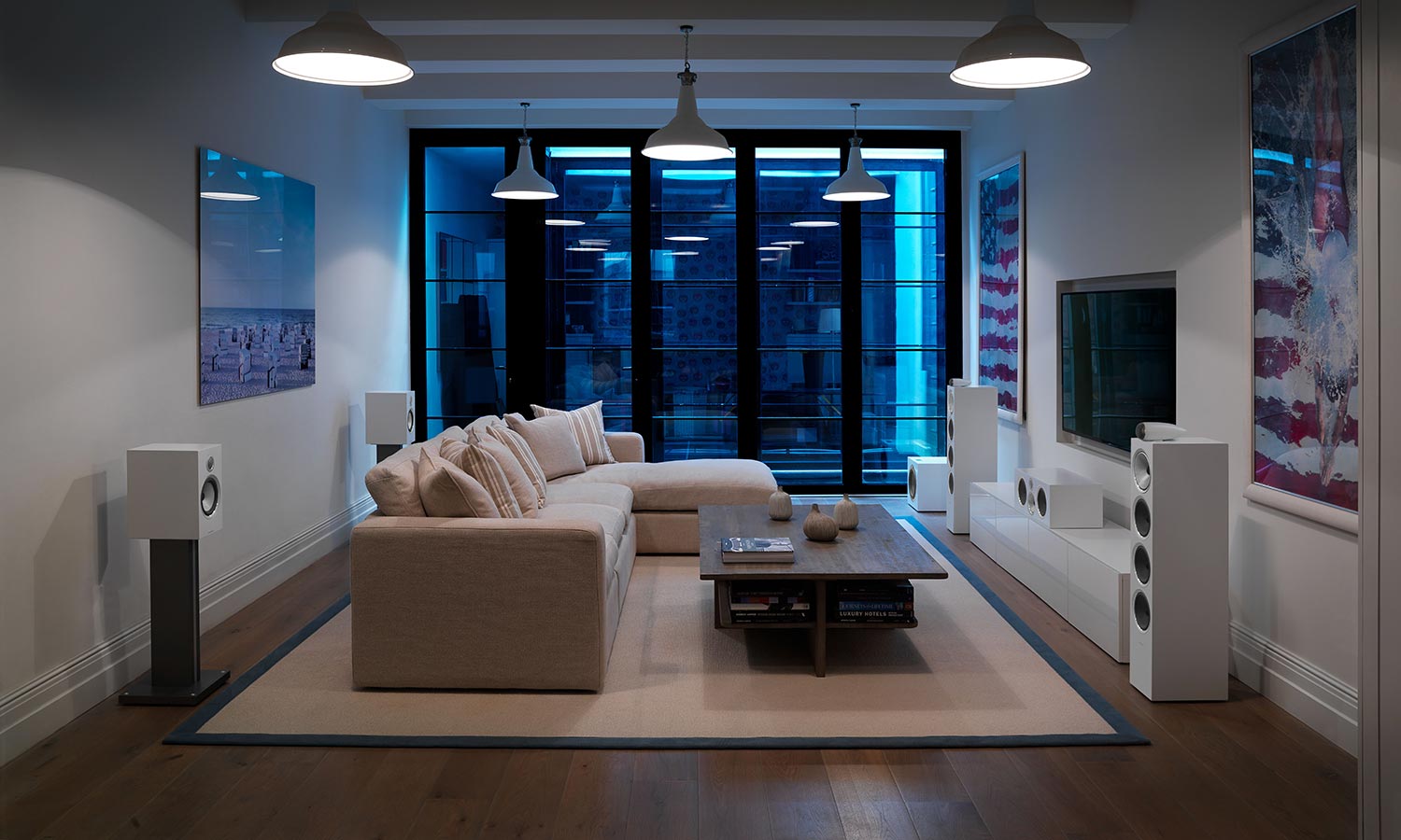 Modern living room with surround sound speakers and large sectional sofa