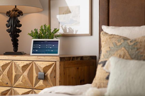 Tablet showing smart home controls on a nightstand