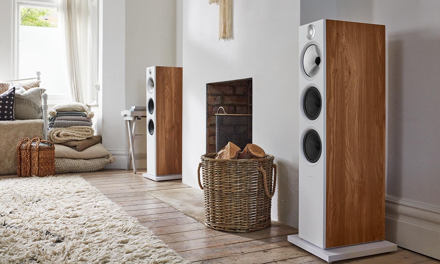 Modern living room with tall wood-accented floorstanding speakers